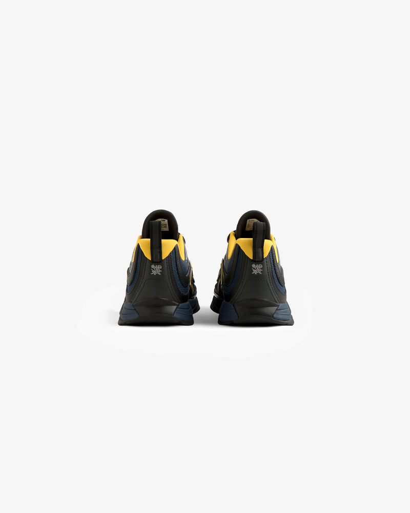 ALD / New Balance RC56 athletic shoes with yellow and navy accents, shown from the back on a white background.
