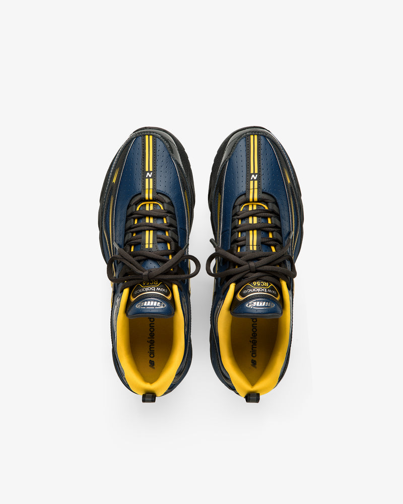 ALD / New Balance RC56 sneakers in blue and yellow with black laces, viewed from above on a white background.