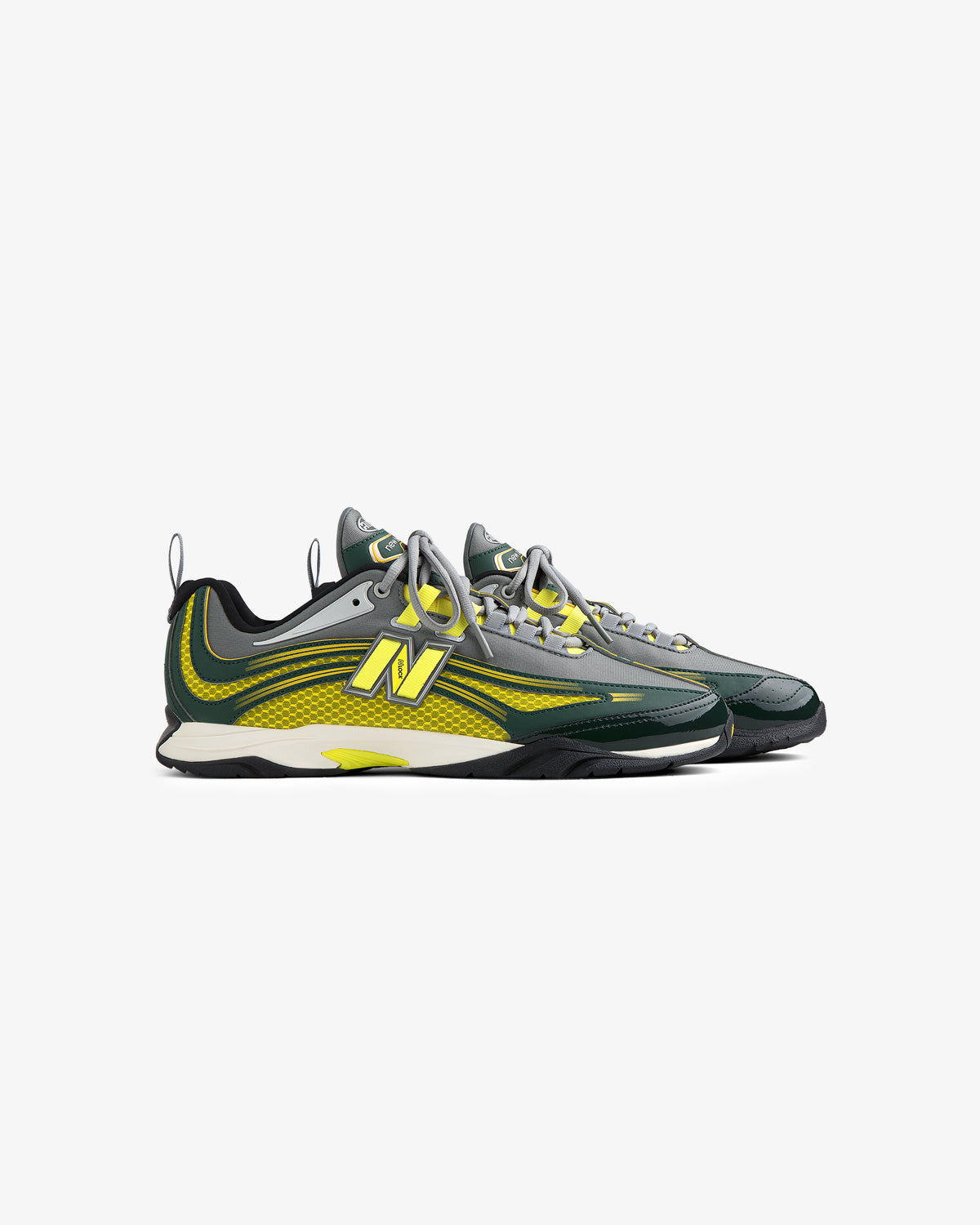 A pair of ALD / New Balance RC56 sneakers in gray, green, and yellow with a modern design on a white background.