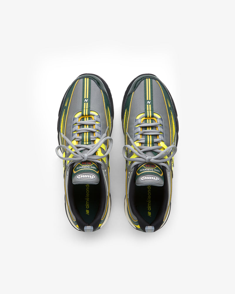 The ALD / New Balance RC56 sneakers in gray, green, and yellow with white laces shown from above on a white background.