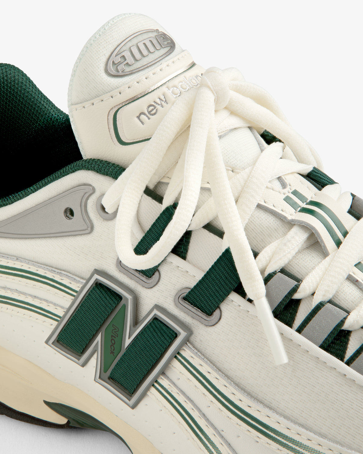 Close-up of a white and green ALD / New Balance RC56 sneaker with white laces and a bold N logo on the side.