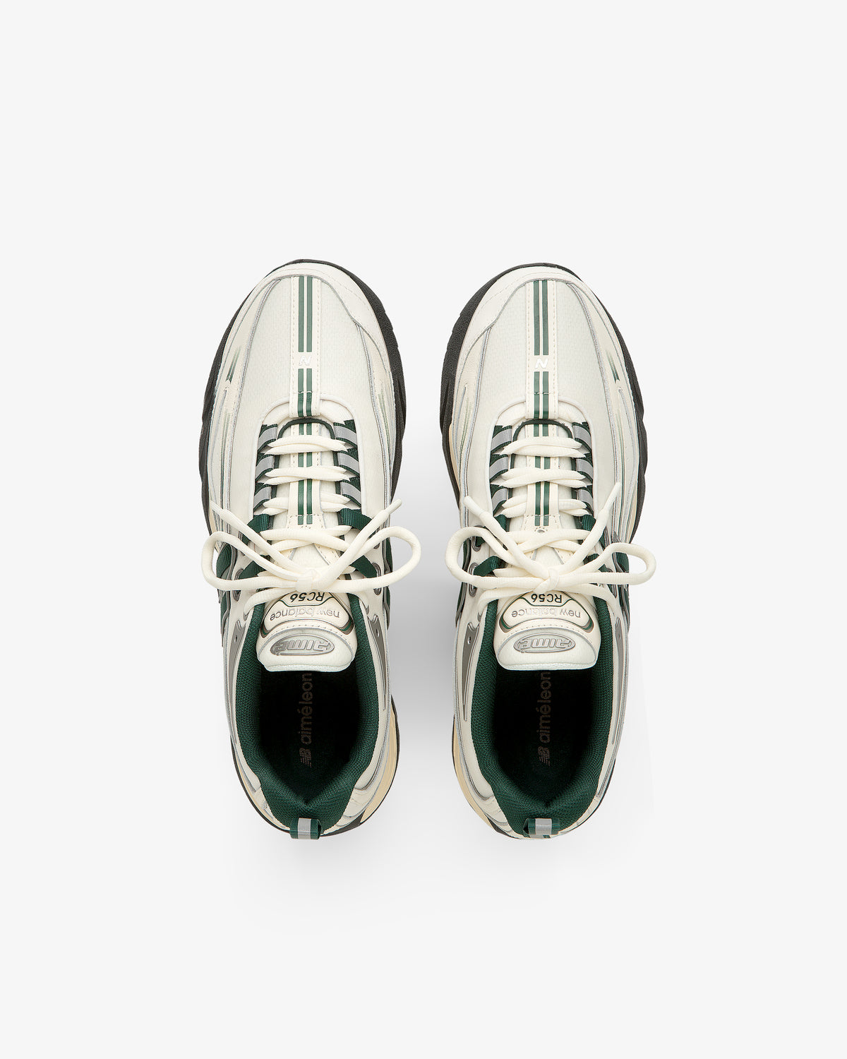 ALD / New Balance RC56 white sneakers with green stripes and black soles, top view on a white background.