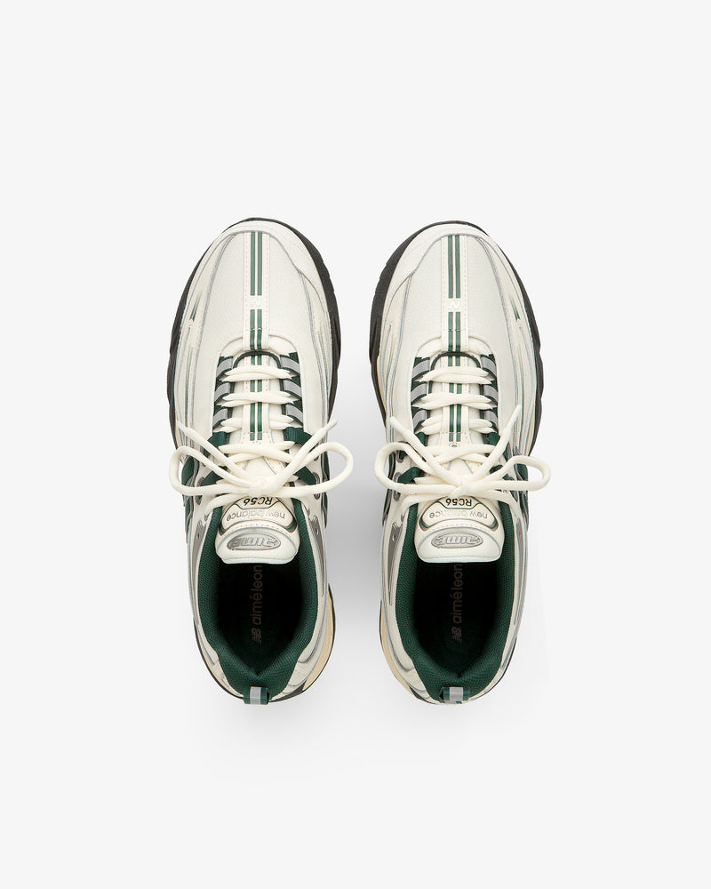 ALD / New Balance RC56 white sneakers with green stripes and black soles, top view on a white background.