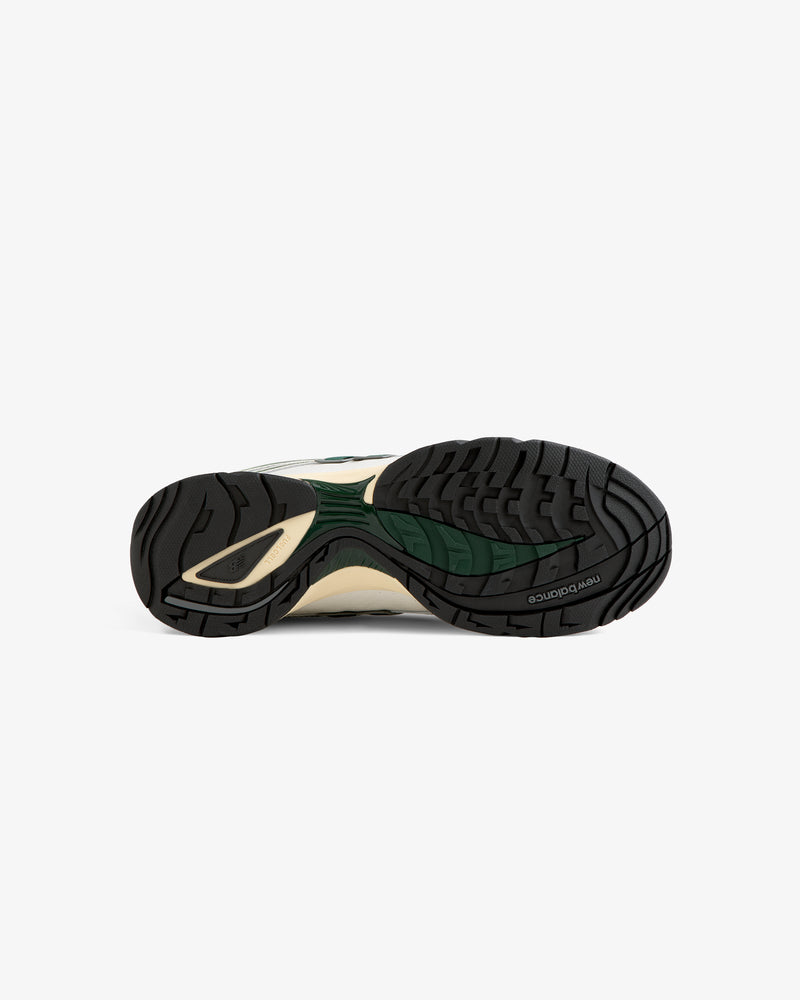 The image shows the black, white, and green rubber sole of the ALD / New Balance RC56 sneaker on a white background.