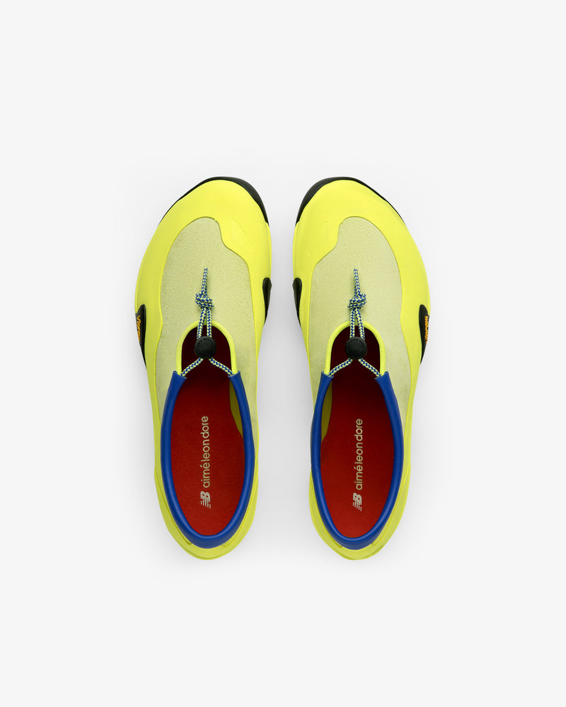 Two ALD / New Balance MT10T Sport Shoes in yellow with blue, black, and red details shown side by side from above.