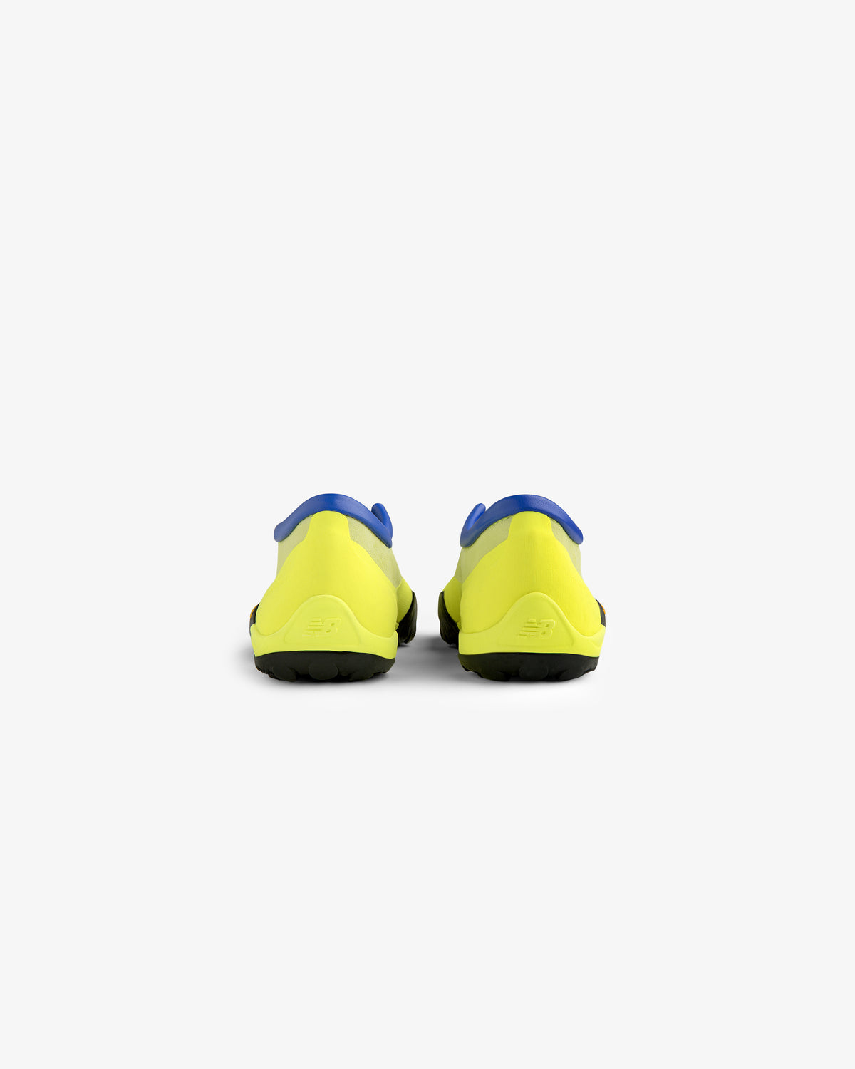 Rear view of ALD / New Balance MT10T Sport Shoe in yellow with blue accents and black soles on white background.