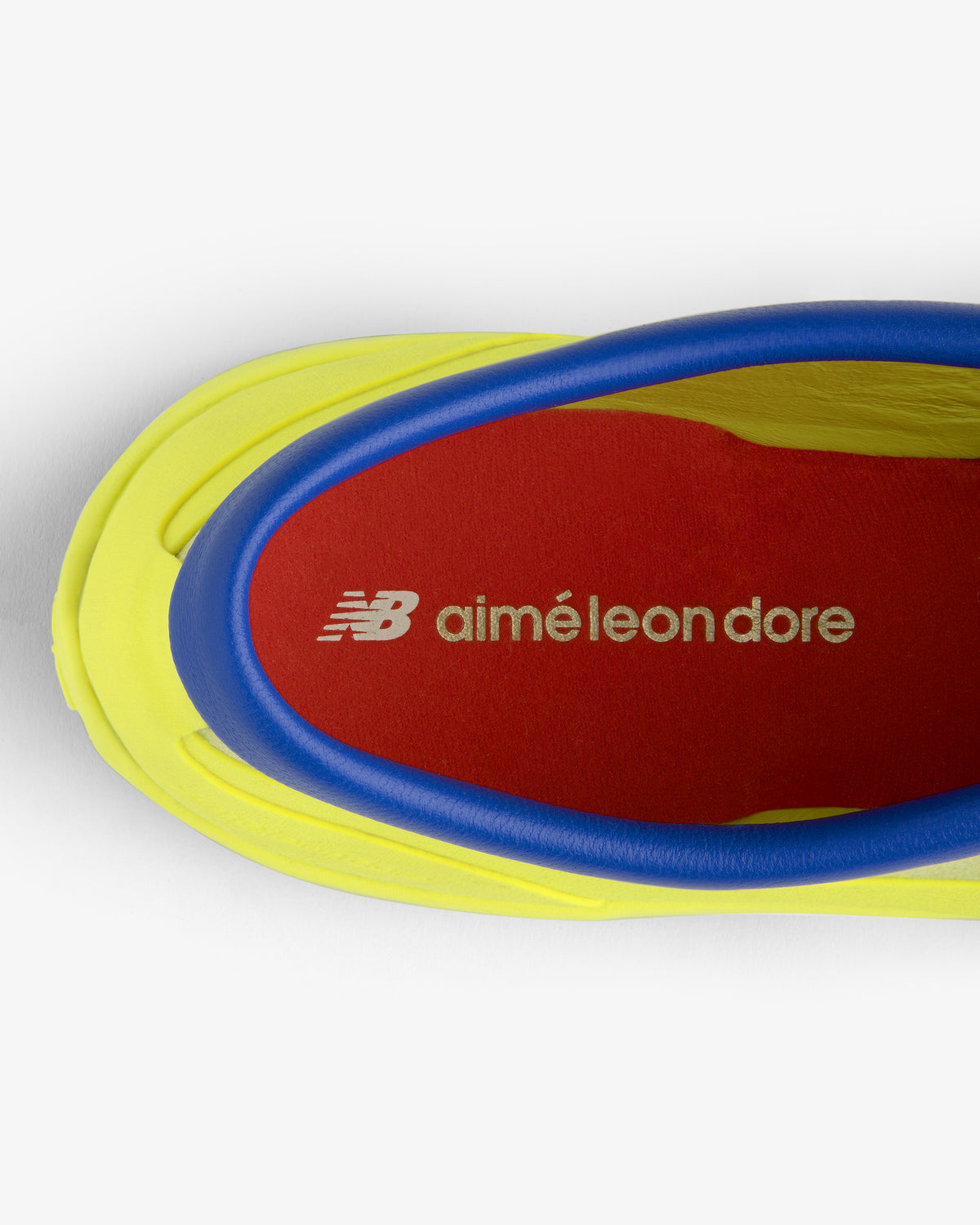 Top view of the ALD / New Balance MT10T Sport Shoe in yellow and blue with a red NB aiméleon dore insole.