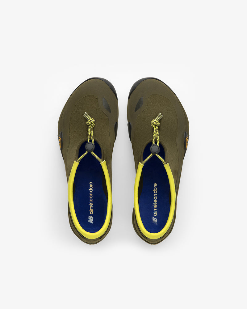 ALD / New Balance MT10T Sport Shoe in olive green with yellow accents and elastic drawstring laces, viewed from above.