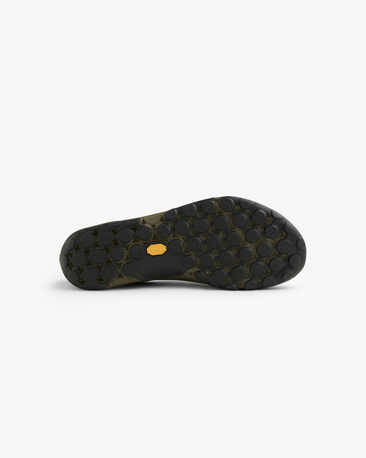 The ALD / New Balance MT10T Sport Shoe features a black sole with hexagonal, circular treads and a central yellow logo.