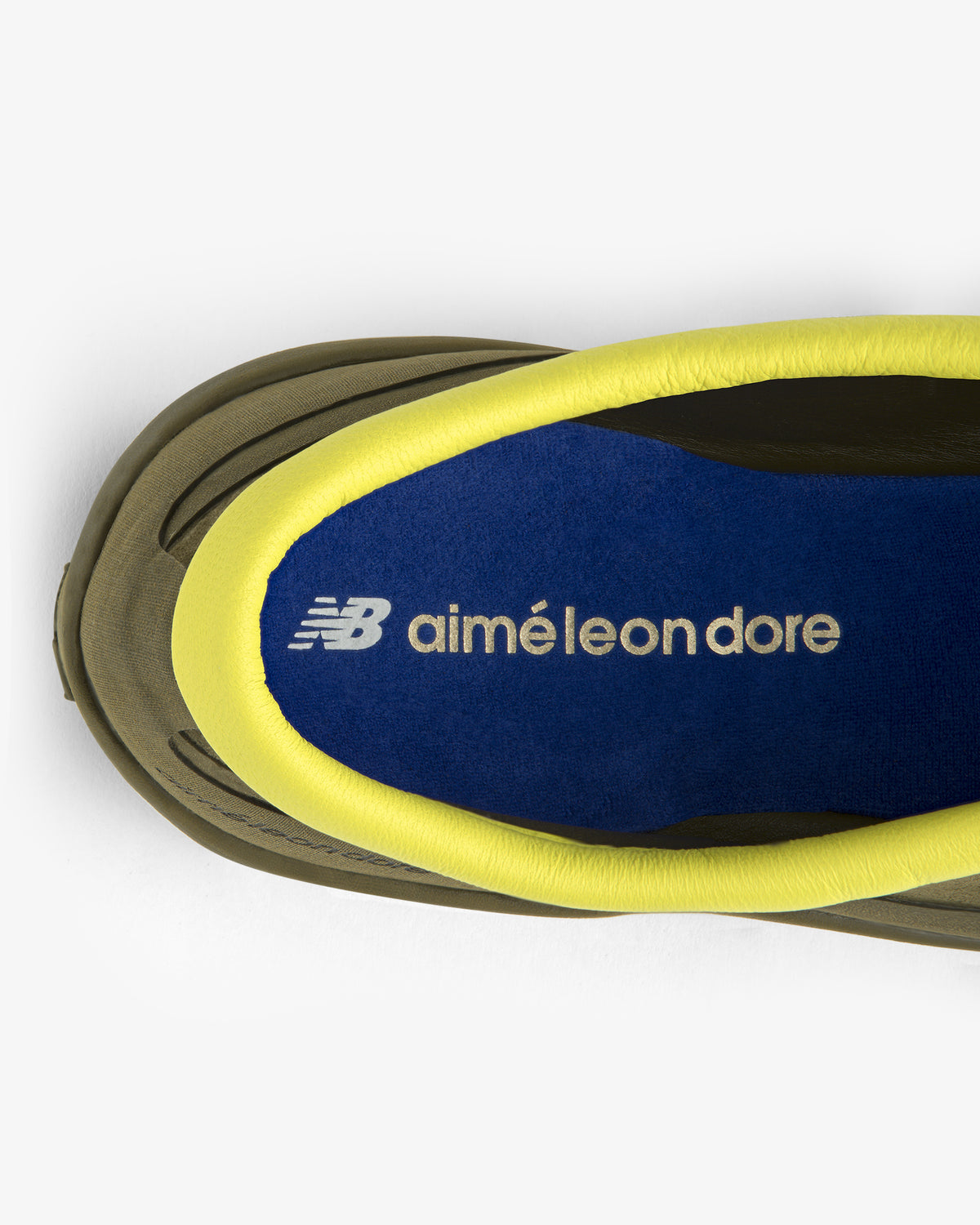 Top view of ALD / New Balance MT10T Sport Shoe with blue insole, NB aimé leon dore text, and yellow padded collar.