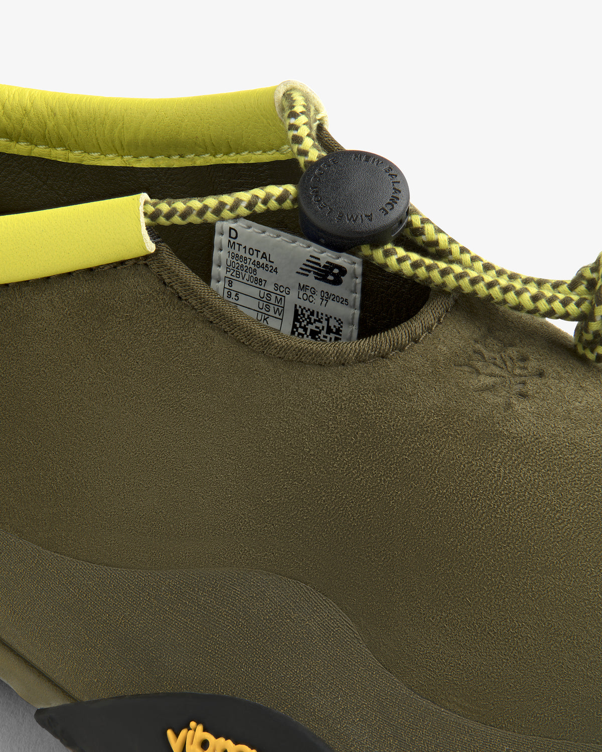 Close-up of the ALD / New Balance MT10T Sport Shoe in olive-green with yellow accents and a round cord toggle.