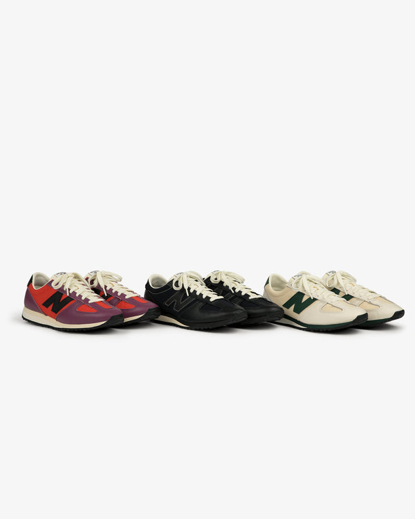 Three ALD / New Balance 471 sneakers in red, black, and beige with colored N logos are side by side on white.