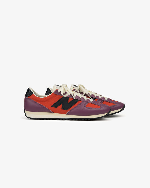 ALD / New Balance 471 sneakers with purple, red, and black accents, white laces, and a black N logo on the side.