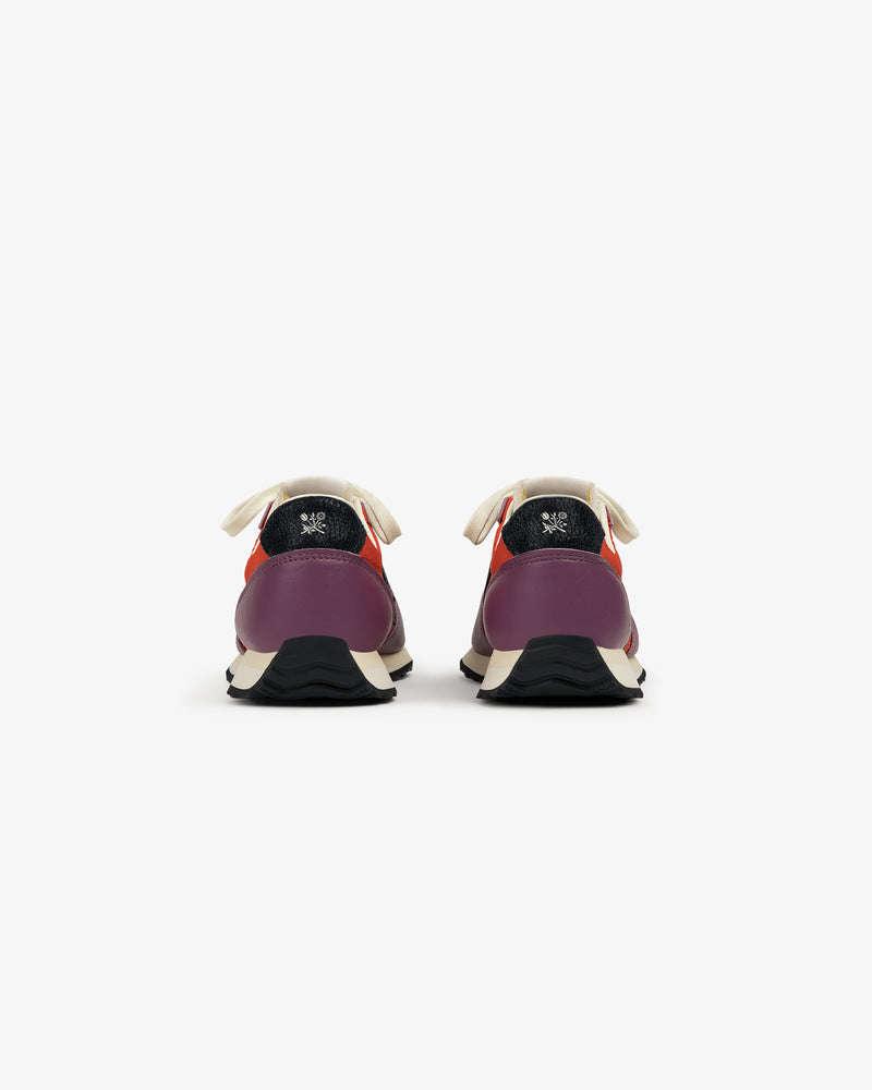 ALD / New Balance 471 sneakers shown from the back in purple, red, and cream with black soles on a white background.