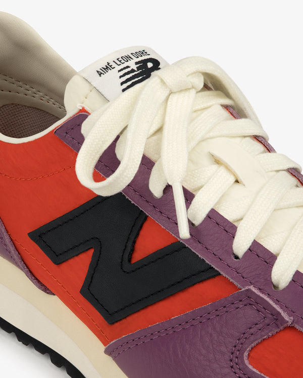 Close-up of the ALD / New Balance 471 sneaker with multicolor panels, white laces, and a black N logo.