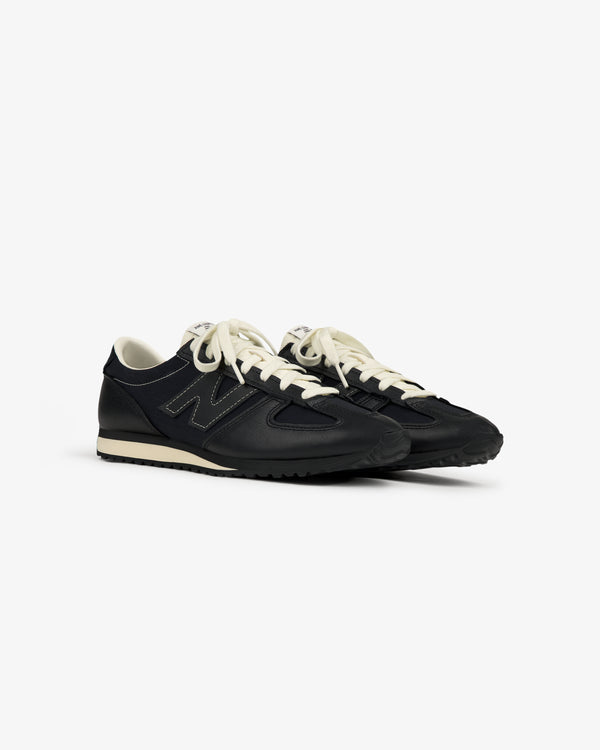 ALD / New Balance 471 sneakers in black with white soles and laces, displayed on a plain white background.