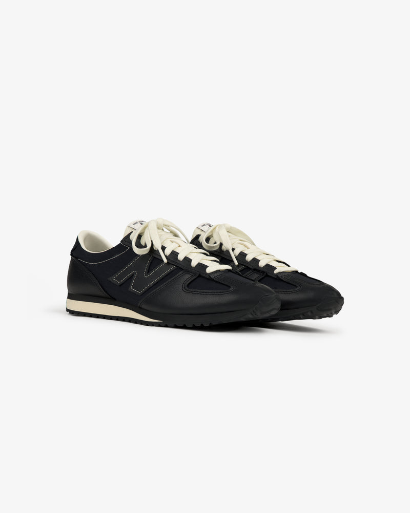 ALD / New Balance 471 sneakers in black with white soles and laces, displayed on a plain white background.