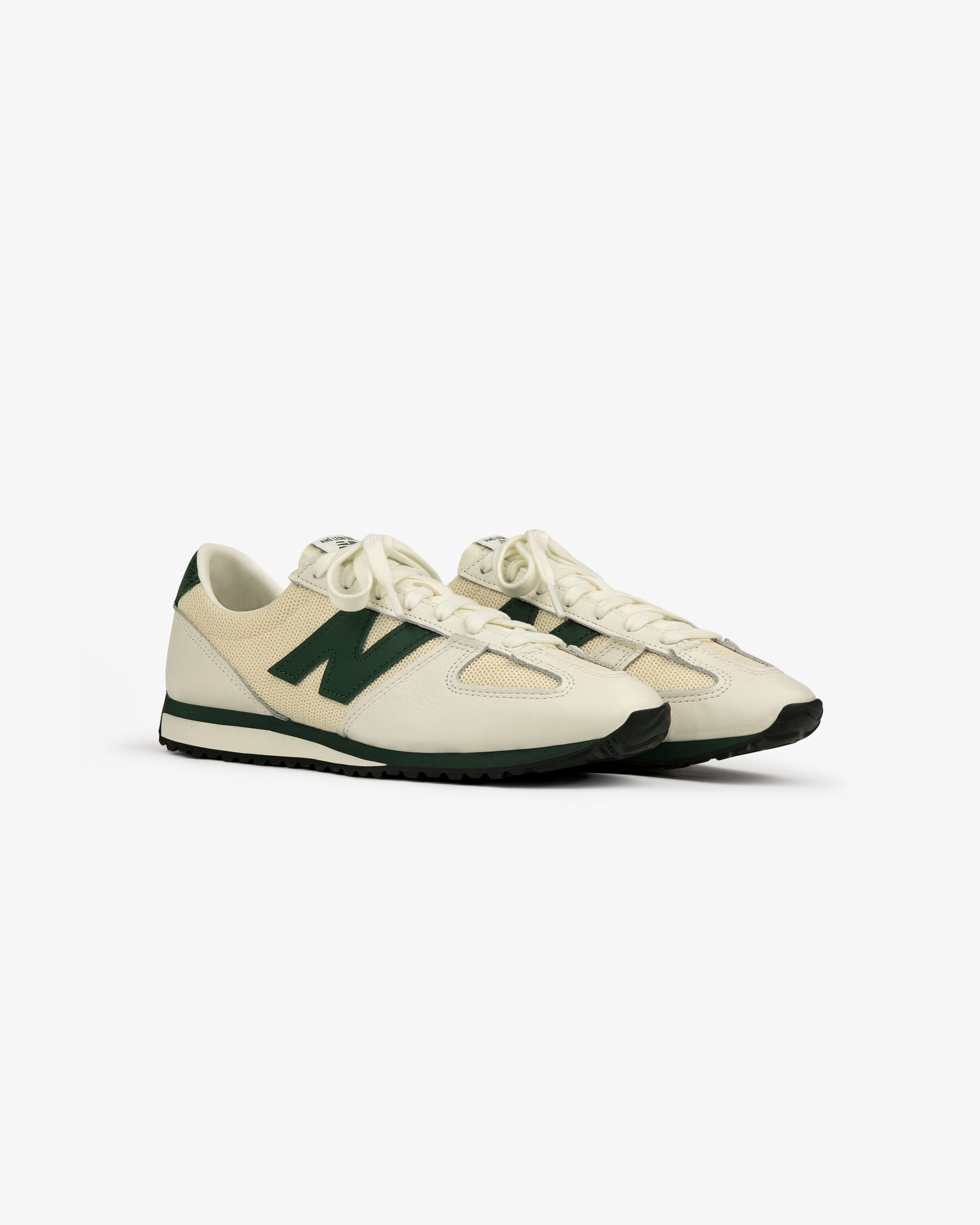 The ALD / New Balance 471 sneakers in off-white and green with black soles, shown at an angle on a white background.