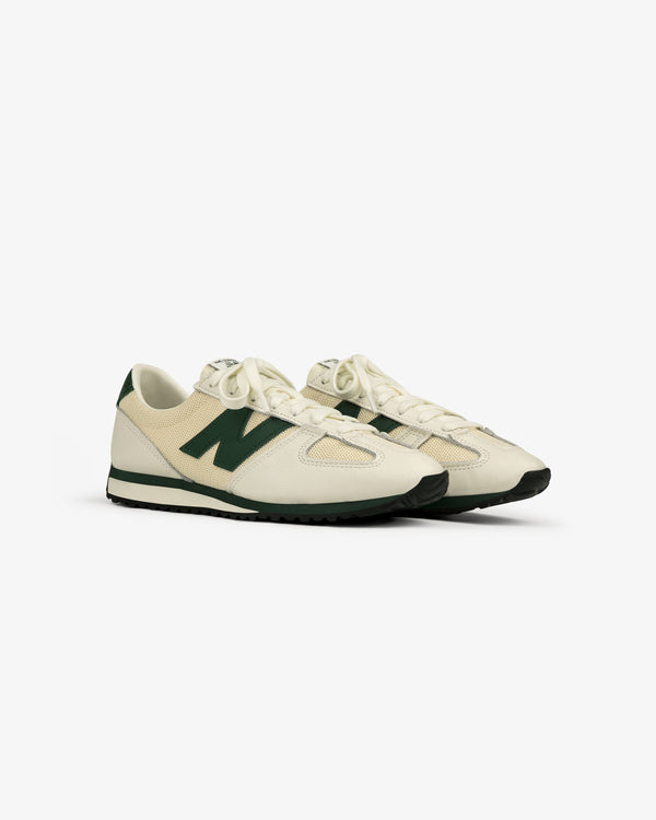 The ALD / New Balance 471 sneakers in off-white and green with black soles, shown at an angle on a white background.