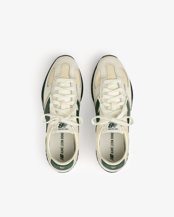 A pair of cream and green ALD / New Balance 471 sneakers viewed from above on a white background.