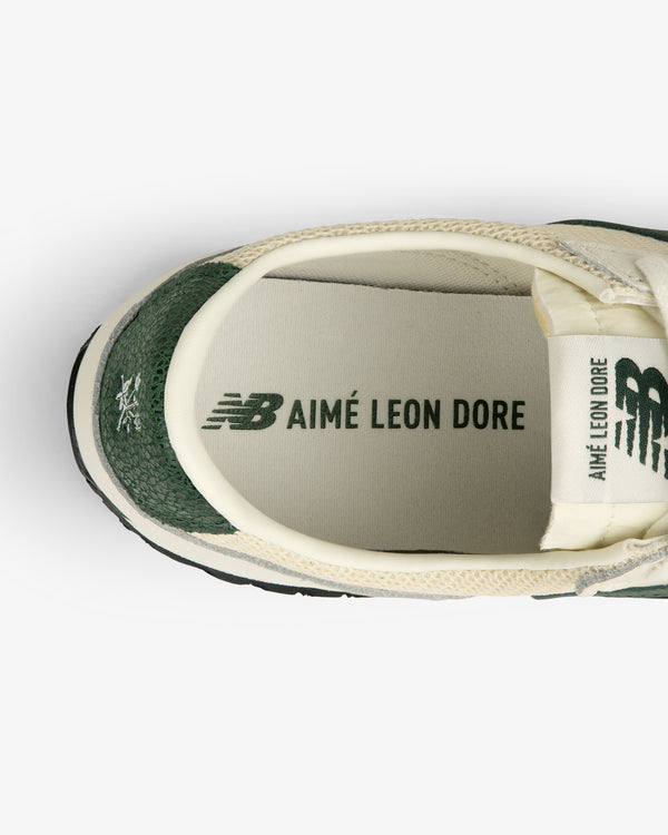 Top view of ALD / New Balance 471 sneaker in green and cream with branded insole and tongue logos.
