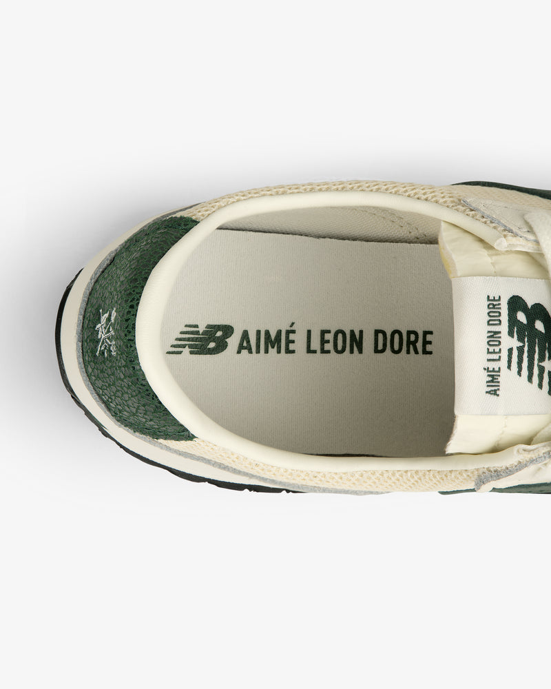 Top view of ALD / New Balance 471 sneaker in green and cream with branded insole and tongue logos.