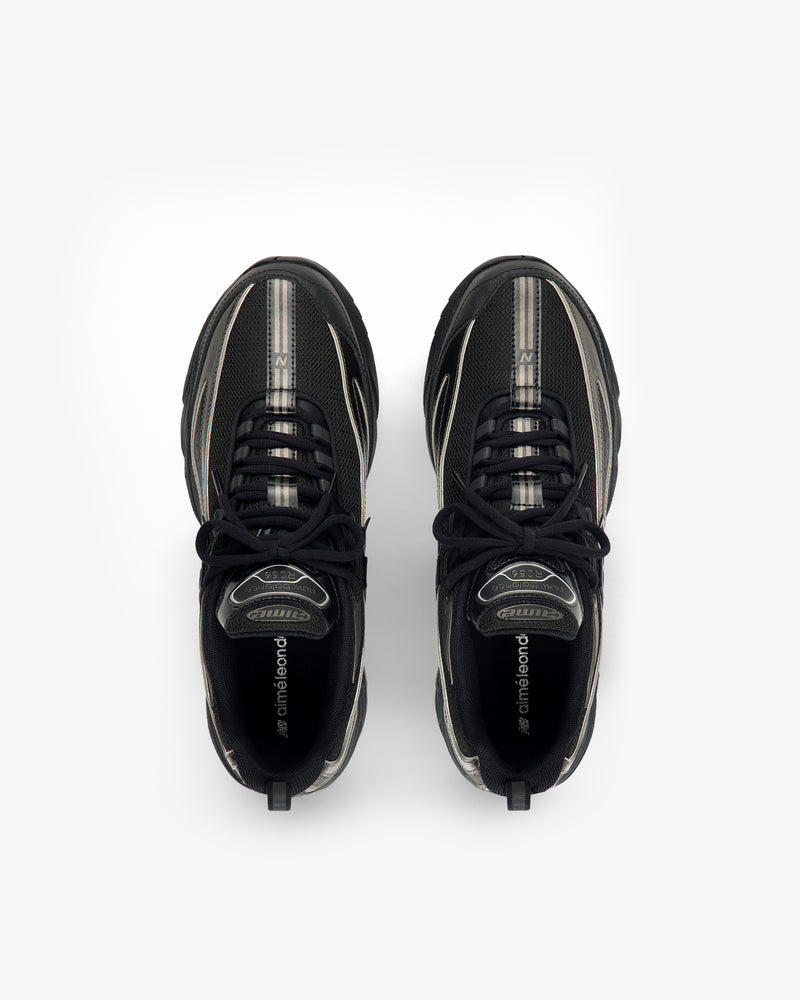 Overhead view of a pair of black ALD / New Balance RC56 sneakers with silver accents.