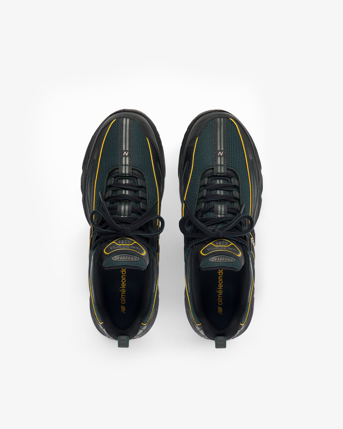 The ALD / New Balance RC56 sneakers in black and green with yellow accents, shown from above on a white background.