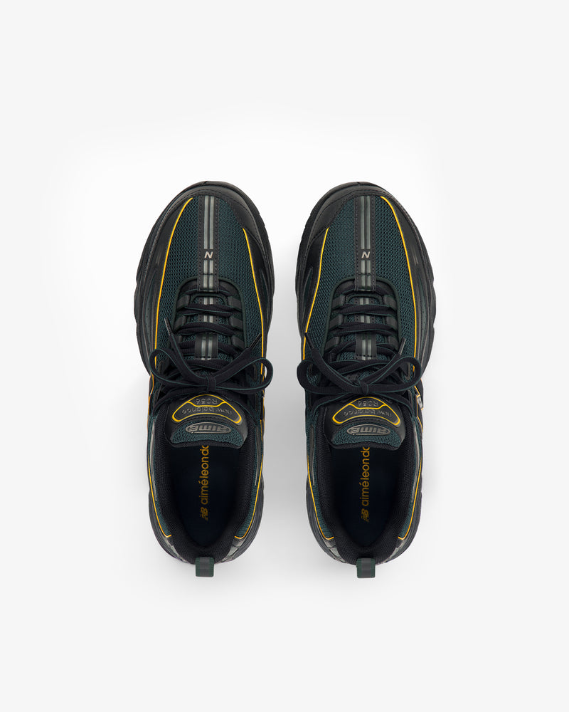 The ALD / New Balance RC56 sneakers in black and green with yellow accents, shown from above on a white background.