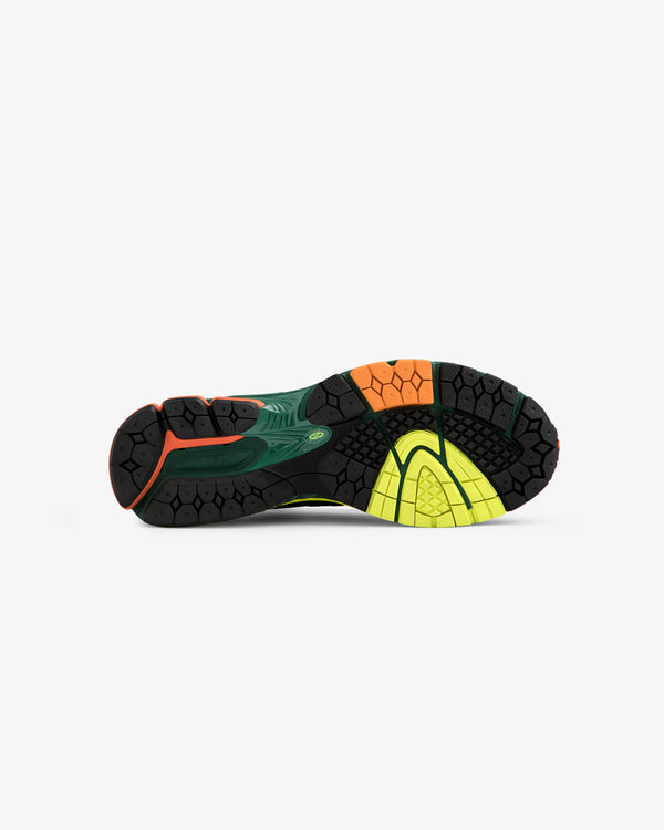 The ALD / New Balance 860v2 sole features black, green, orange, and yellow traction on a white background.