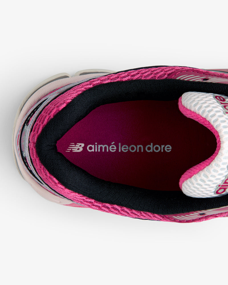 Top view of a pink ALD / New Balance 860v2 sneaker with NB aimé leon dore text on the insole.