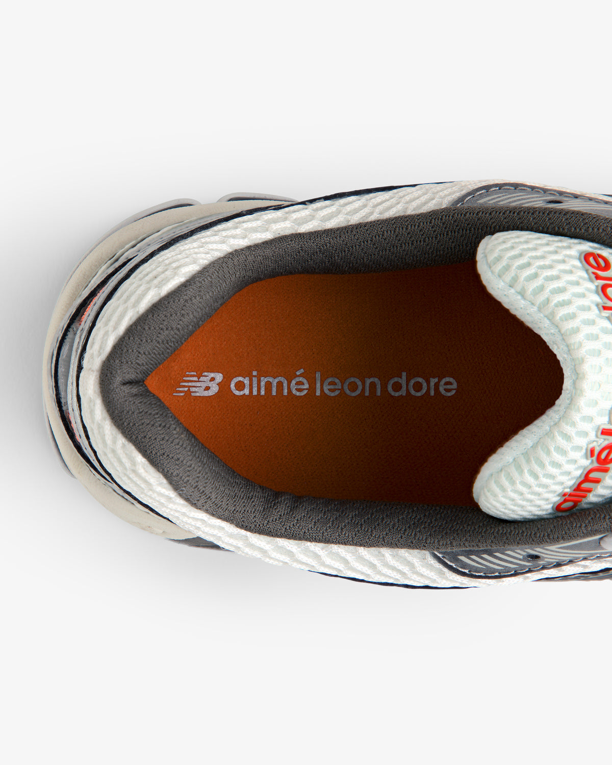 Top view of ALD / New Balance 860v2 sneaker featuring orange insole with New Balance and Aimé Leon Dore branding.
