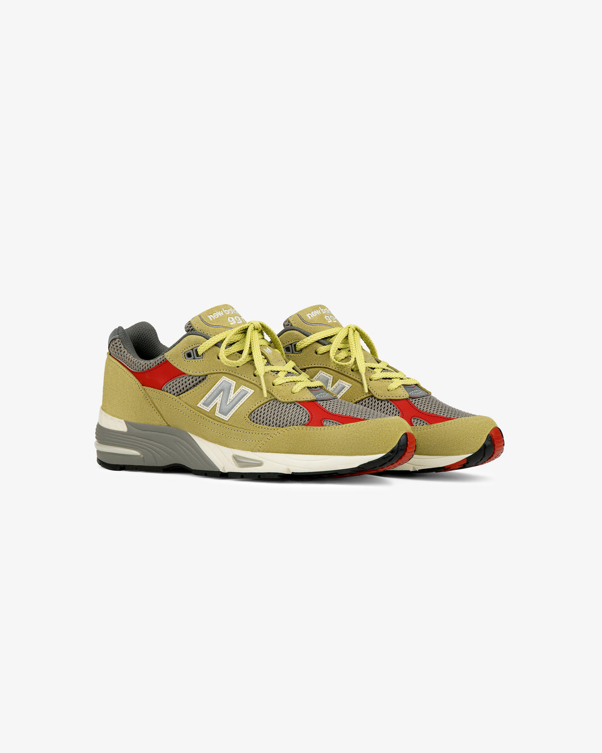 A pair of ALD / New Balance Made in UK 991 sneakers in yellow, grey, and red on a white background.