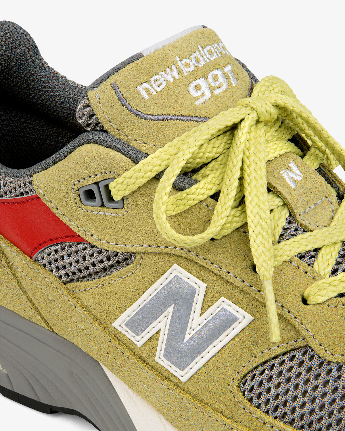 Close-up of the ALD / New Balance Made in UK 991 in yellow suede with red accents, yellow laces, and mesh details.