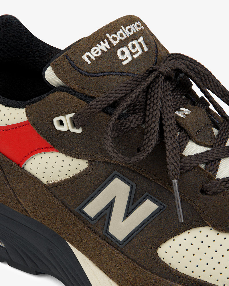 Close-up of an ALD / New Balance Made in UK 991 sneaker, showing laces, logo, and tongue branding.