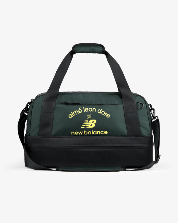 ALD / New Balance Travel Duffle Bag in dark green and black with yellow logos on the front.