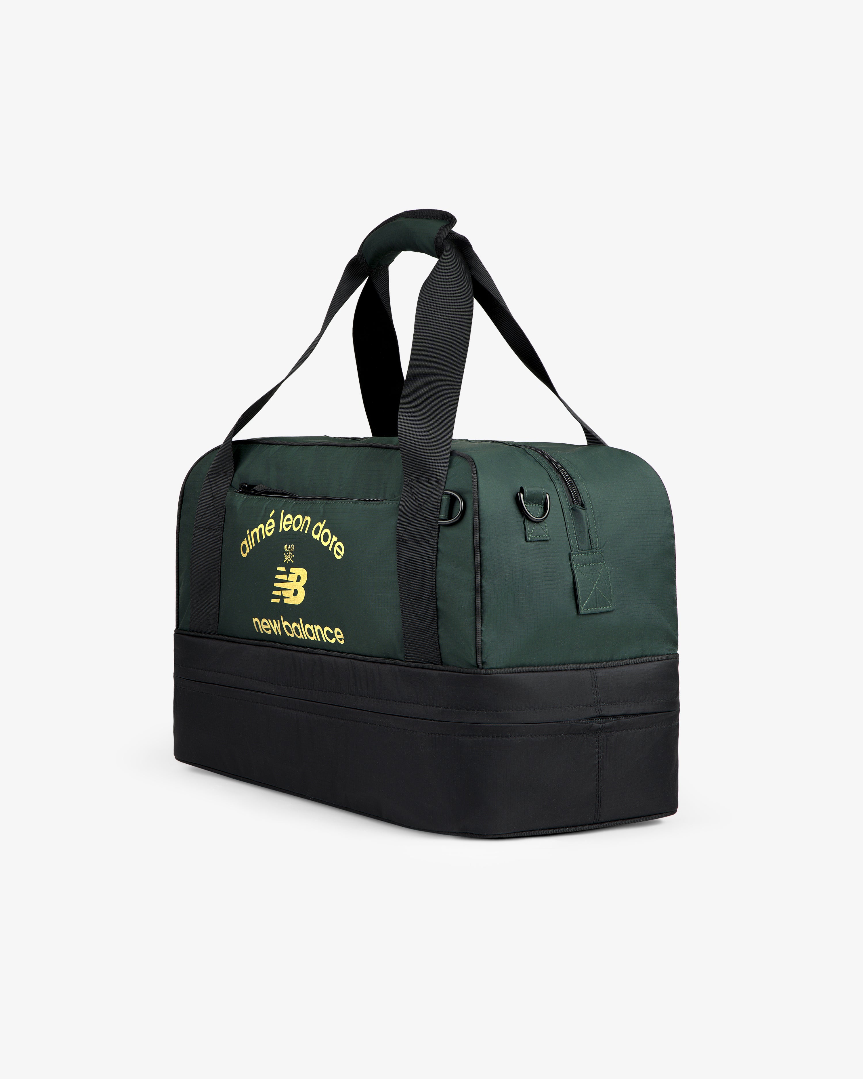 ALD / New Balance Travel Duffle Bag in dark green and black with yellow logos on the side.