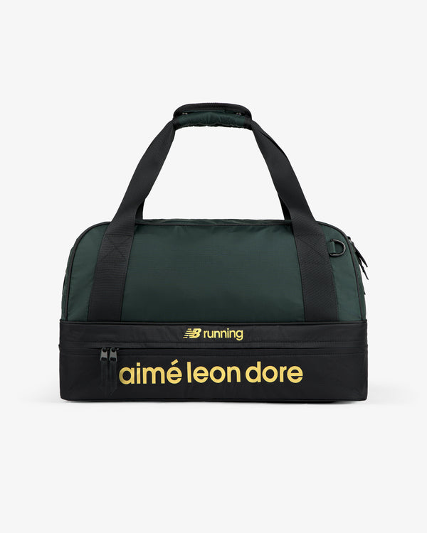 The ALD / New Balance Travel Duffle Bag is dark green and black with yellow "NB running" and "aimé leon dore" text.