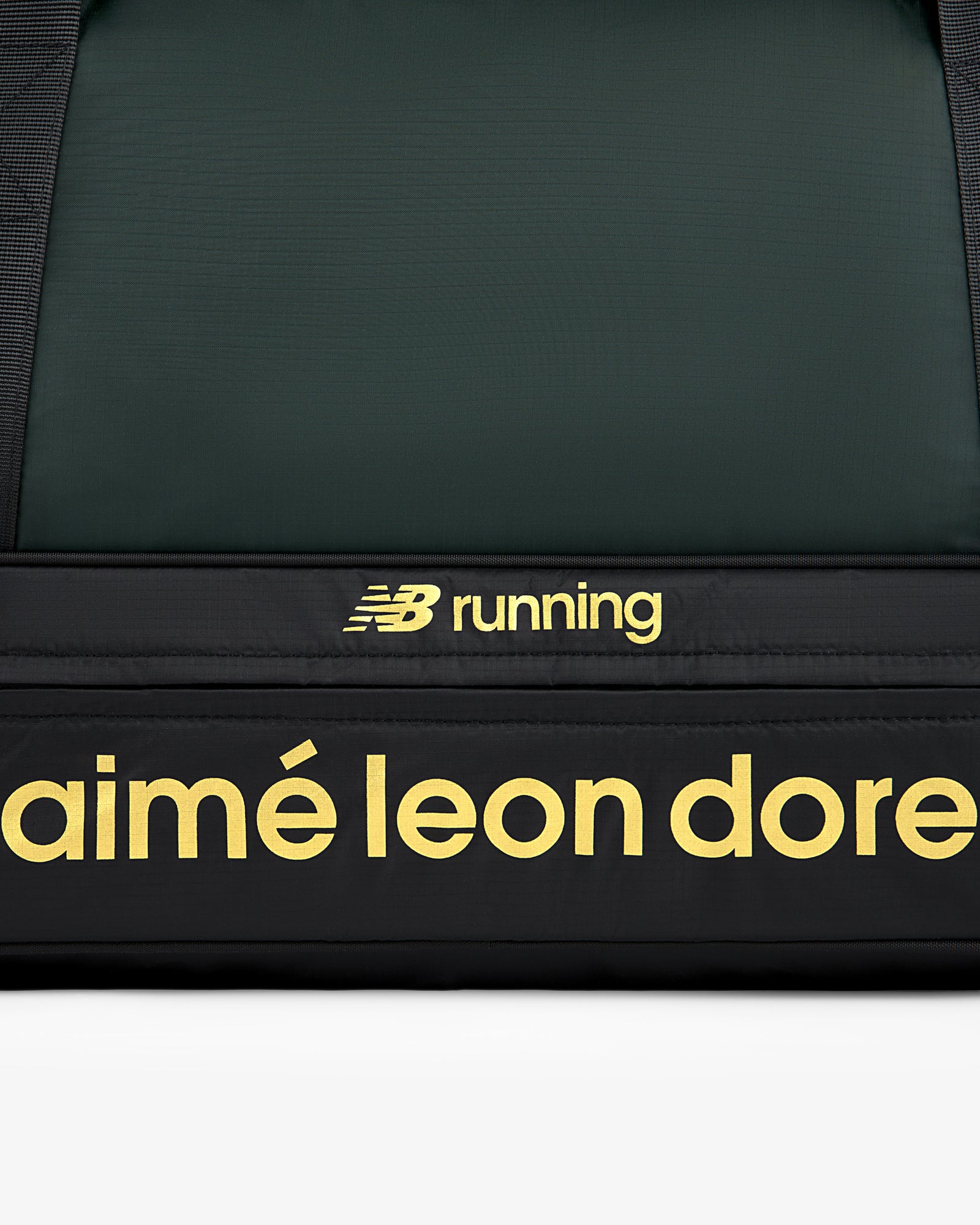 Close-up of the ALD / New Balance Travel Duffle Bag, black with yellow branding.