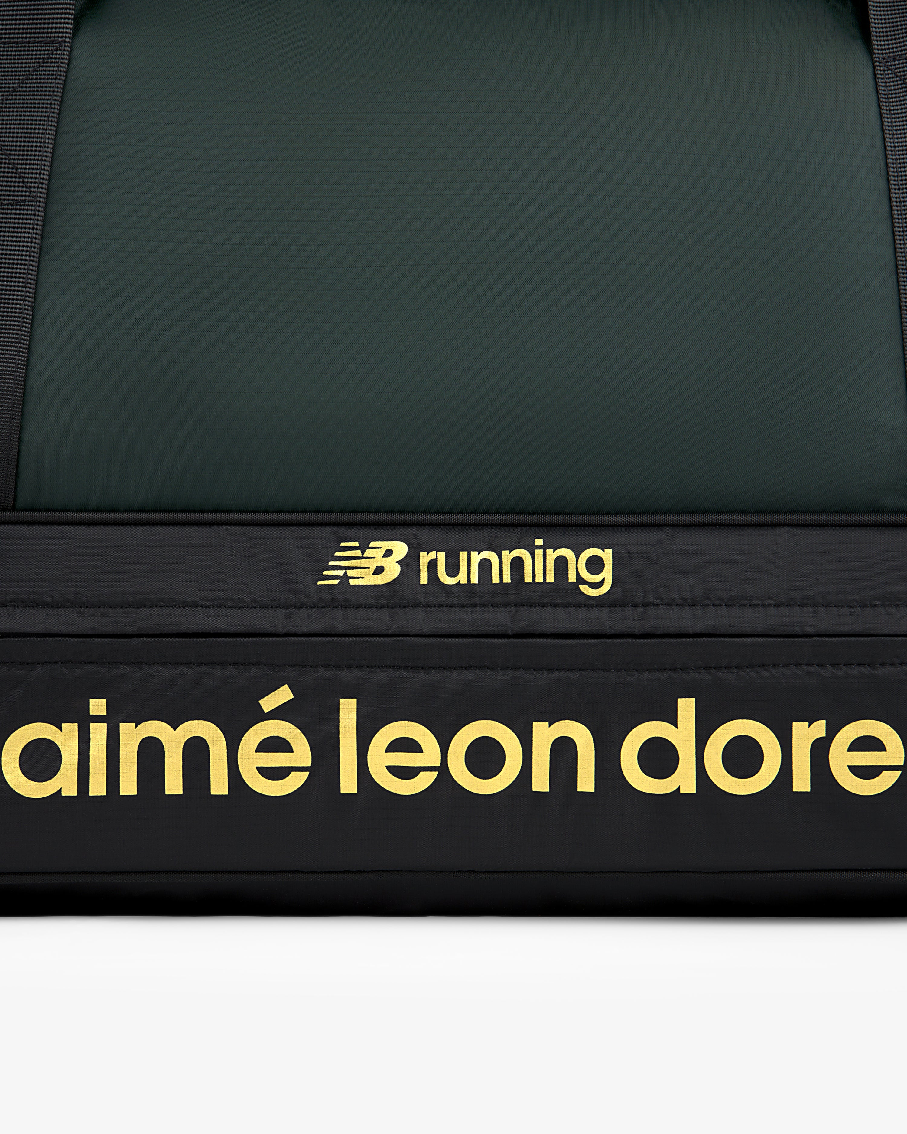 Close-up of the ALD / New Balance Travel Duffle Bag, black with yellow branding.