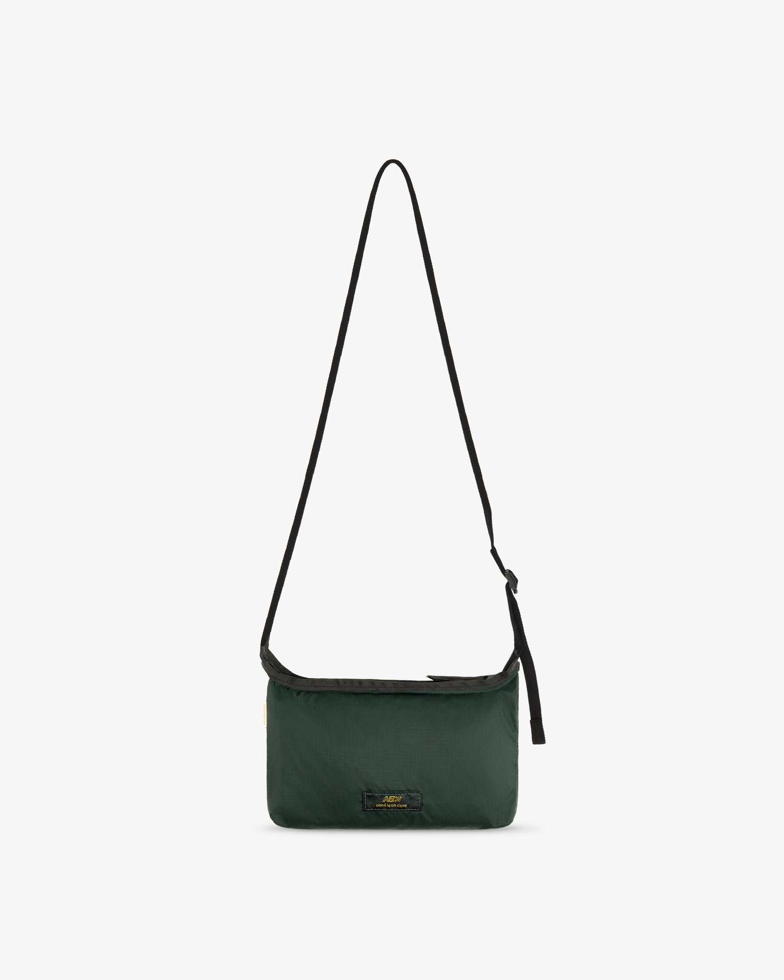 ALD / New Balance Nylon Sling Pouch in dark green with black adjustable strap on a white background.