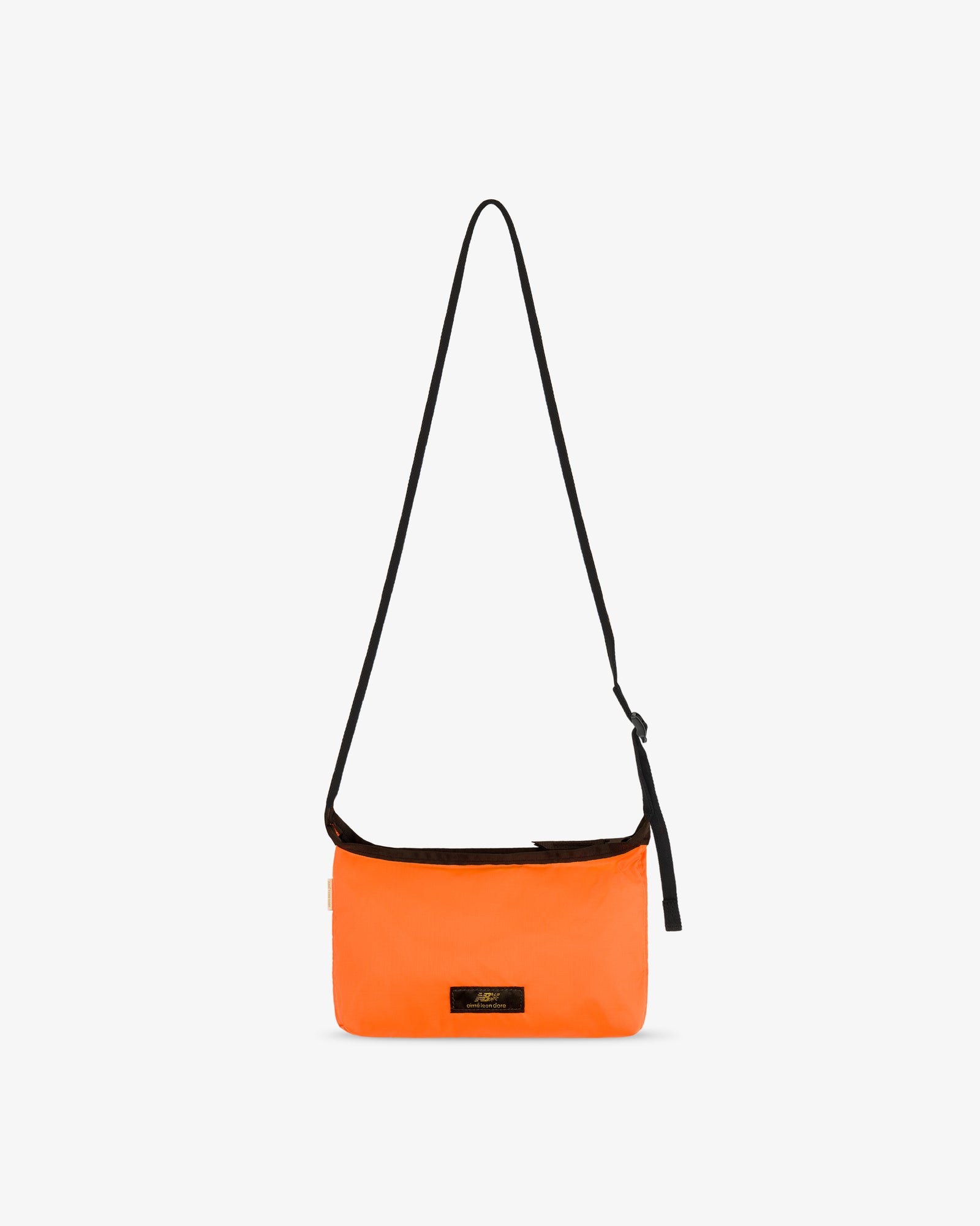ALD / New Balance Nylon Sling Pouch in bright orange with long black strap and small black front label on white background.