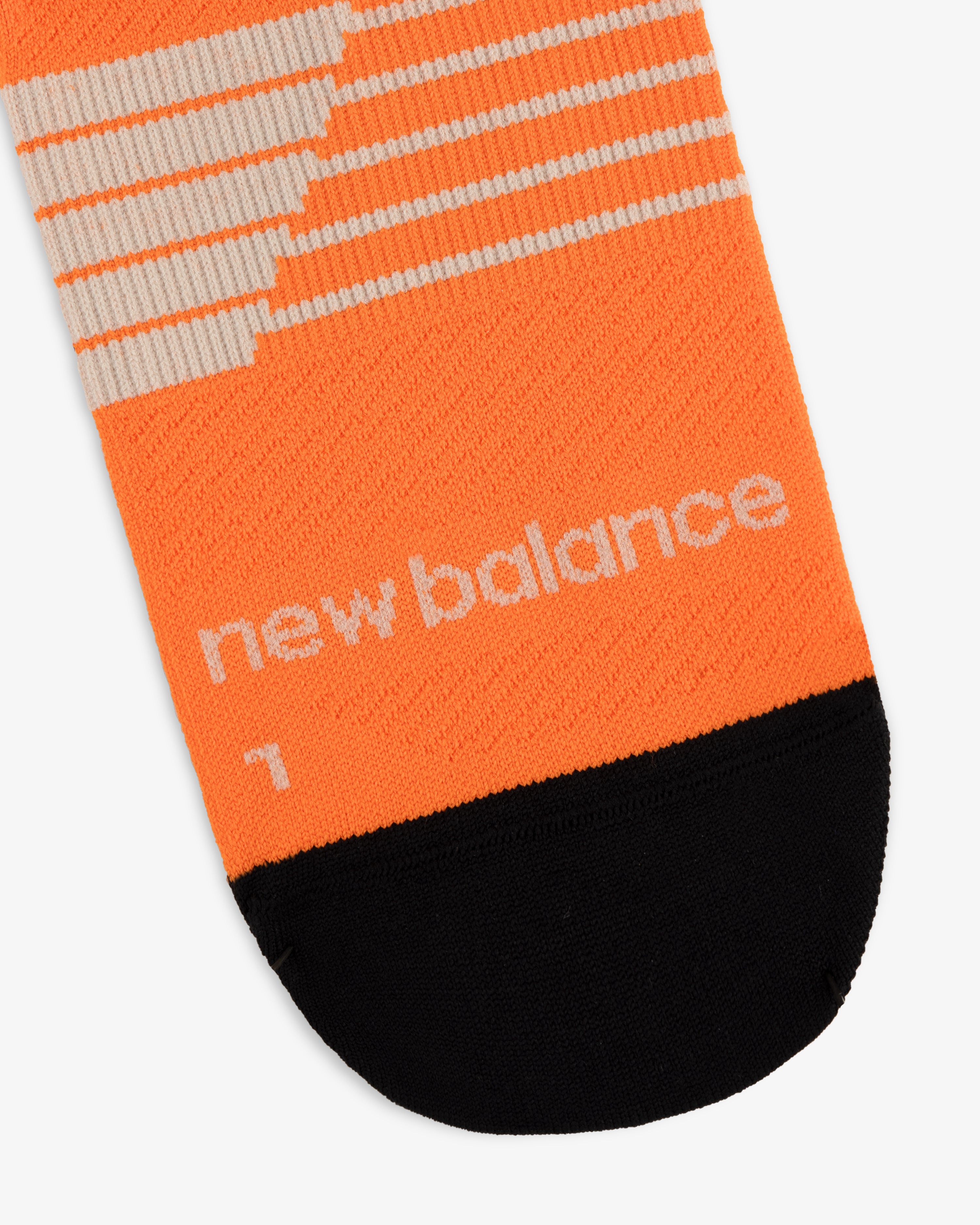 Orange and black ALD / New Balance Running Crew Sock with a white number 1 printed near the toe.