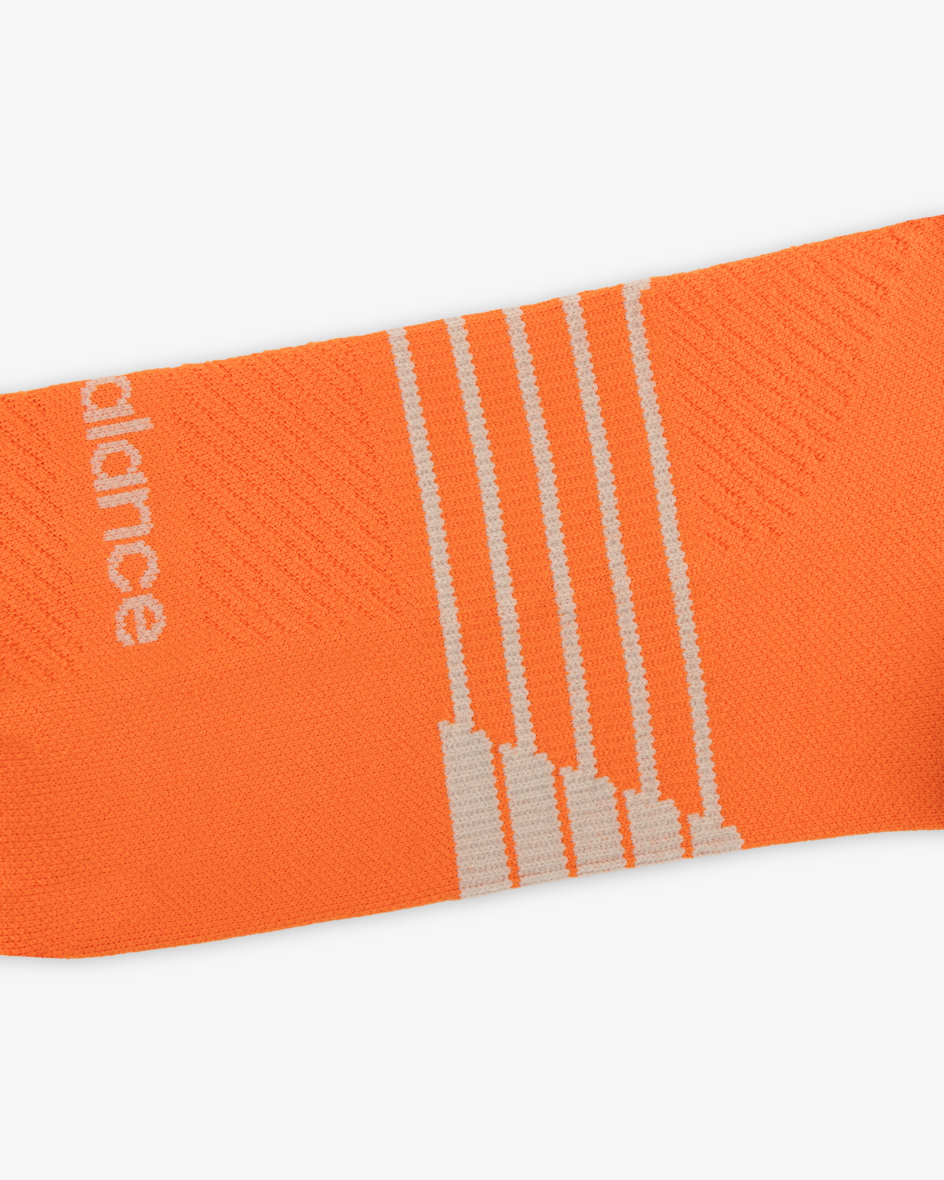 ALD / New Balance Running Crew Sock: orange with white diagonal stripes and partial white text on left side.