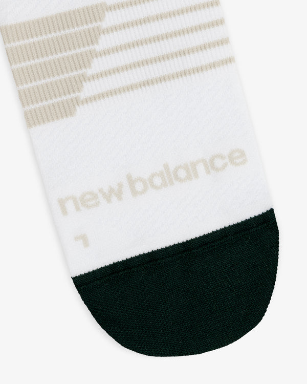 ALD / New Balance Running Crew Sock: white with beige stripes, black toe, and beige "new balance" near the toe.