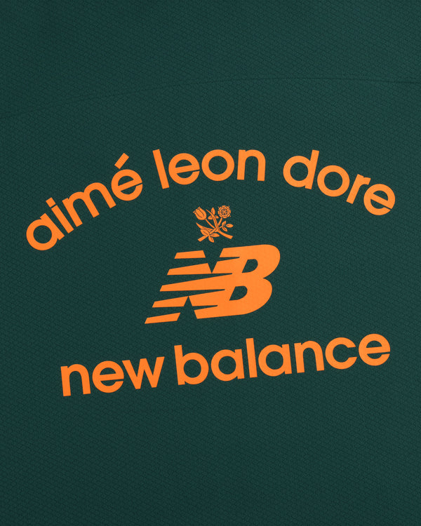 Orange "aimé leon dore" and New Balance text with NB logo and rose on dark green ALD / New Balance Full-Zip Warmup Hoodie.