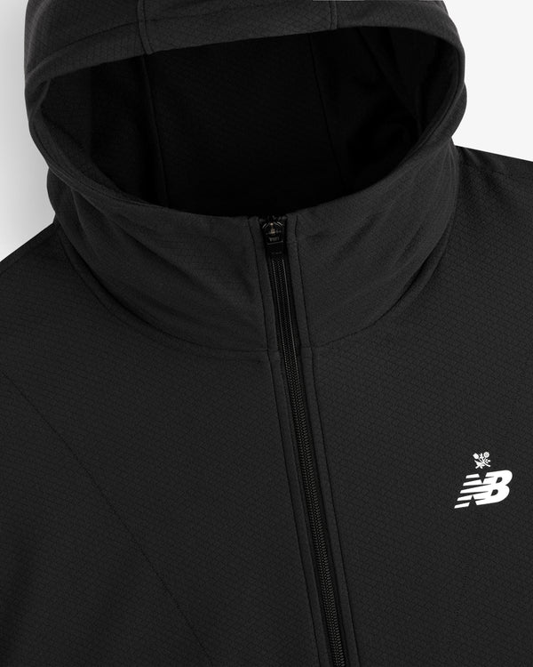 Close-up of the ALD / New Balance Full-Zip Warmup Hoodie in black, featuring a chest logo and zip closure.