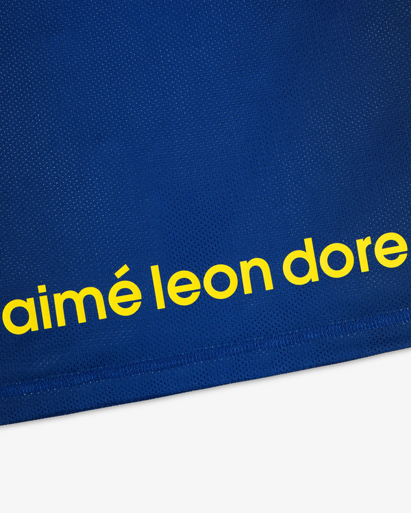 Blue ALD / New Balance Running Gradient Singlet with 'aimé leon dore' in bold yellow lowercase near the bottom.
