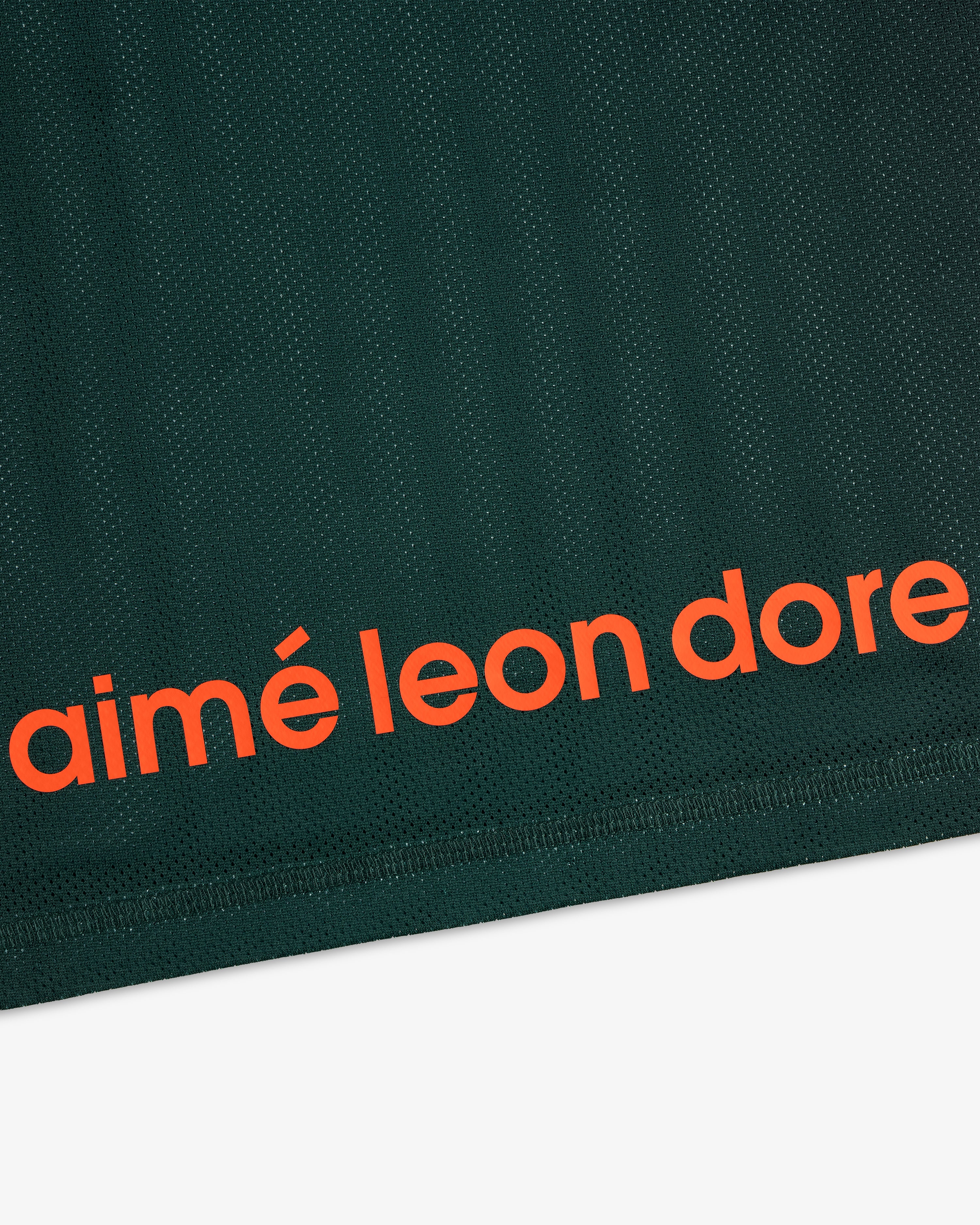 Dark green ALD / New Balance Running Gradient Singlet with bold orange aimé leon dore text near the bottom edge.