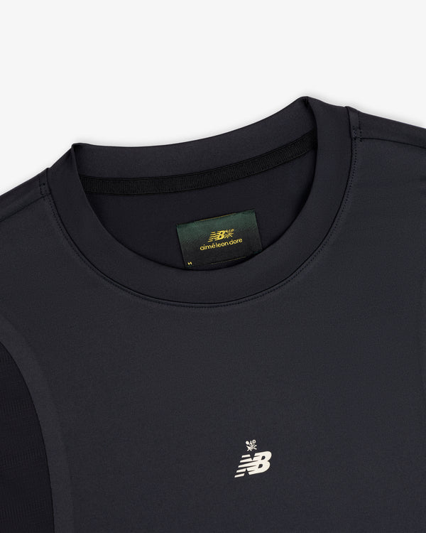 Close-up of a black ALD / New Balance Performance Long-Sleeve Tee with small logo and visible green collar label.